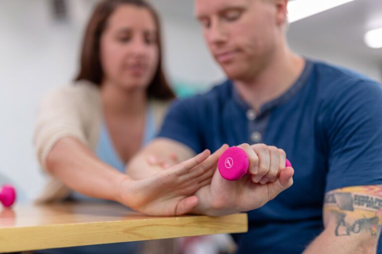 Young ethnic girl working on her balance with a physical therapist